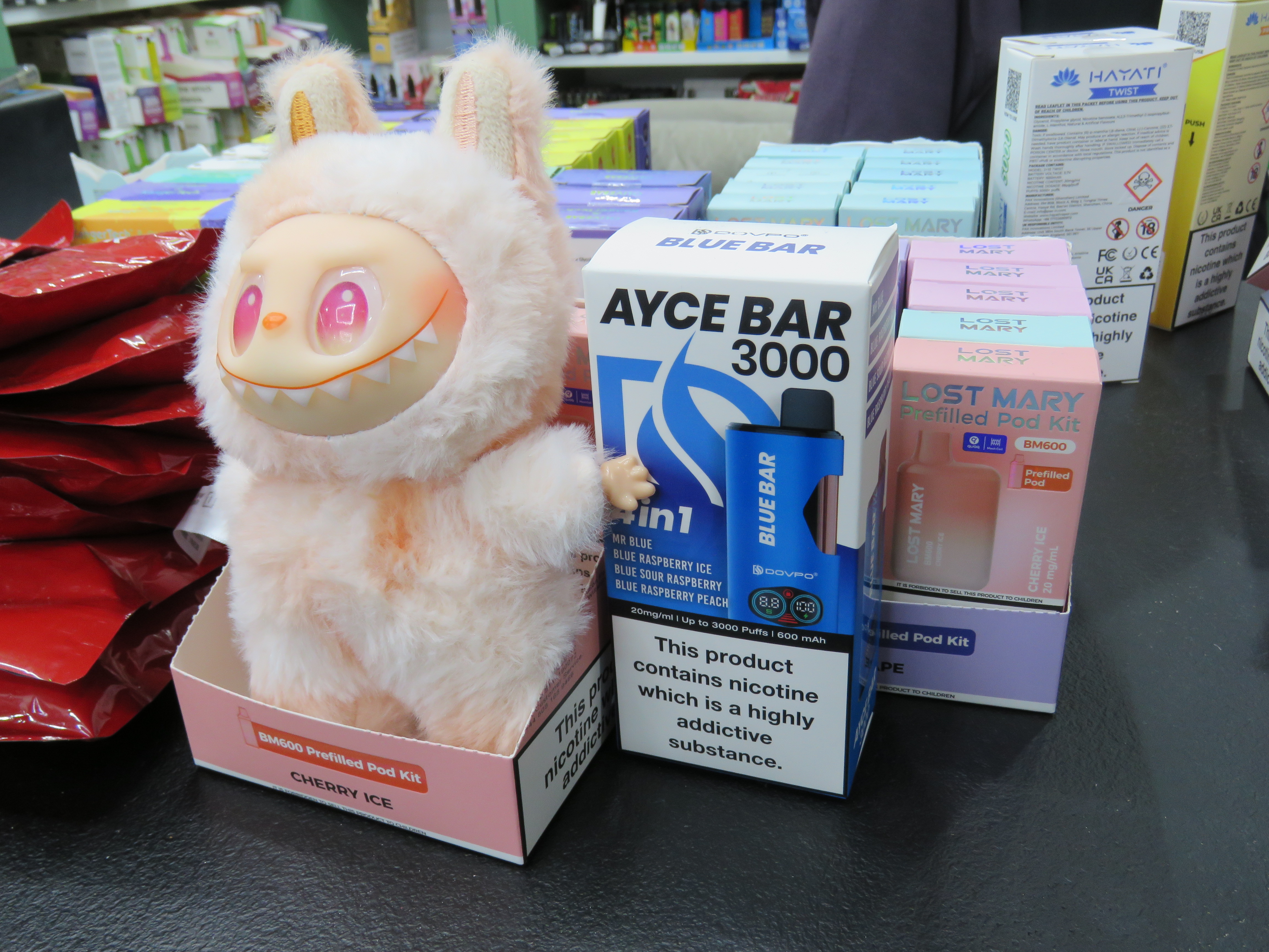 Buckingham & Surrey - Small toy next to a box
